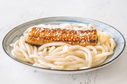 Thick udon noodles topped with glazed eel, richly coated in savory unagi sauce