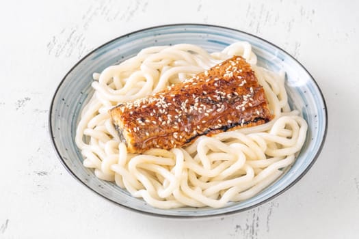 Thick udon noodles topped with glazed eel, richly coated in savory unagi sauce