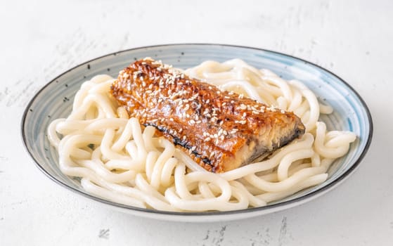 Thick udon noodles topped with glazed eel, richly coated in savory unagi sauce