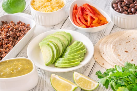 Tortillas surrounded by vibrant toppings and fillings, ready to assemble flavorful tacos
