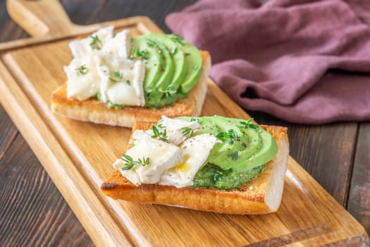 Toasted ciabatta sandwiches layered with brie, avocado, and creamy spinach, delicately herbed