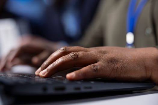 Solar panel manufacturing plant researcher typing on laptop keyboard, developing new solar energy systems prototypes. Factory expert researching innovative photovoltaics materials on notebook, close up