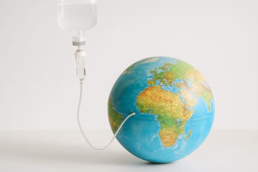AI generated realistic globe with medical iv bag and tube symbolizing environmental care concept white background climate change earth protection healthcare metaphor