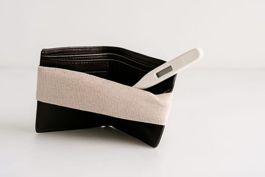 AI generated realistic empty men's wallet with bandage symbolizing financial injury and economic recovery concept white background money struggle healing metaphor