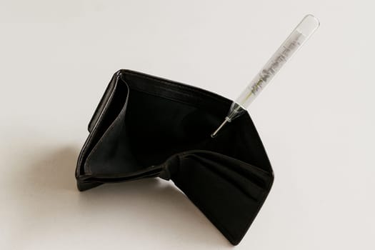 AI generated realistic empty men's wallet with medical thermometer showing high temperature symbolizing financial crisis and economic emergency concept white background money problem metaphor
