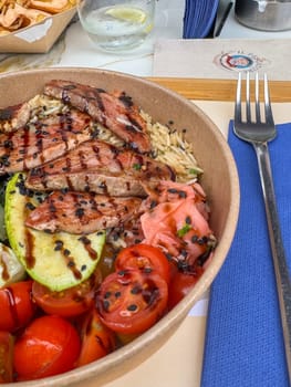 Tivat, Montenegro - April 25, 2025: grilled tuna with vegetables and salad.tuna dish at Il Pescatore cafe. High quality photo