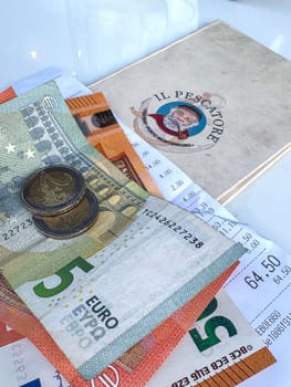 Tivat, Montenegro - April 25, 2025: a check with money on the table at Il Pescatore cafe in Marina Porto Montenegro