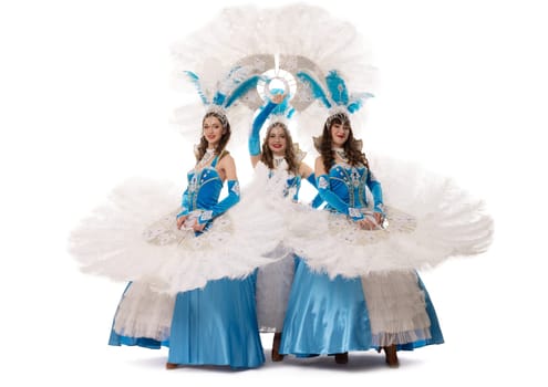 Full body of content female in dance costumes with feather fans looking at camera against white background in light studio