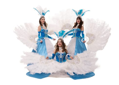 content female in dance costumes with feather fans looking at camera isolated in light studio
