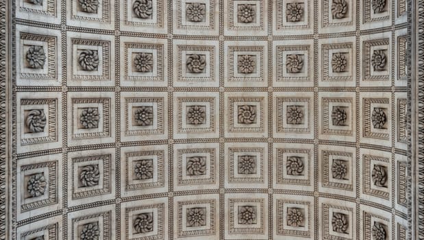 France, Paris - May 03, 2025 - Upward View to the ornate stone carvings ceiling centre inside of the famous Arc de Triomphe. Stunning details under the arch of Triumphal Arch, Iconic touristic architectural landmark of Paris, use it as your Wallpaper, Poster and Copy space, Selective focus.