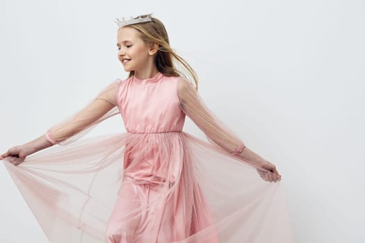 Delightful image of a cheerful young girl in a pink tulle dress, expressing happiness while twirling Ideal for children s fashion, joy, and special occasions
