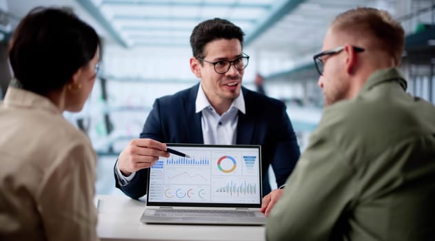 Young Couple Consults Hispanic Financial Planner For Future Financial Security.