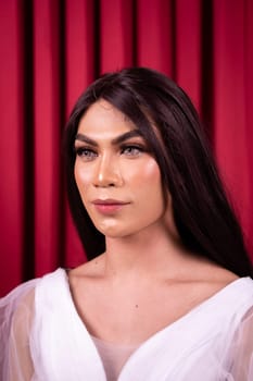 Luxury Asian woman in a white dress with a red curtain in the background inside the studio