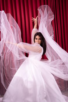 Beautiful woman wearing a white wedding dress in her private party