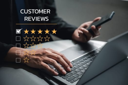Business excellence is achieved through quality service. A man's hand using a smartphone and laptop with a 5-star popup for feedback review and customer satisfaction survey