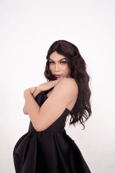 Portrait shoot of Asian woman with black dress poses in black hair inside the studio
