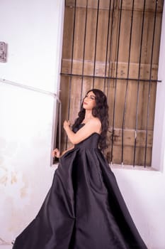 Asian woman standing in the wooden window while wearing a black dress and black hair