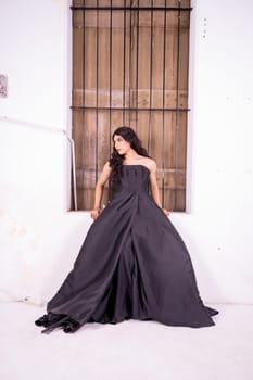 Asian woman standing in the wooden window while wearing a black dress and black hair