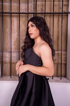 A beautiful Asian woman poses in front of the wooden windows in elegance face inside the white room