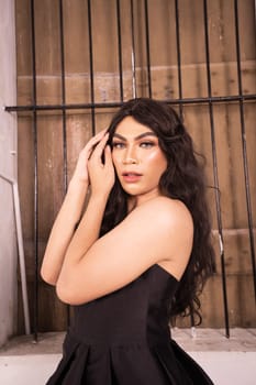 Portrait of an Asian woman with black hair being lonely with the wooden window in the background