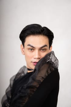 Beautiful Asian man wearing a black dance costume before the performance begins at the backstage
