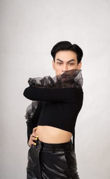 Beautiful Asian man wearing a black dance costume before the performance begins at the backstage