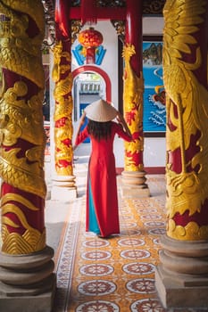 back of an Asian female tourist traveling in a temple on pagoda in Vietnam in Asia
