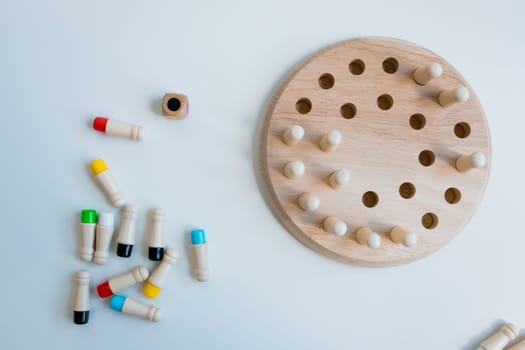 Wooden strategy puzzle with pegs and board for brain training.