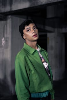 an Asian man is standing in an abandoned building in an eccentric outfit at night