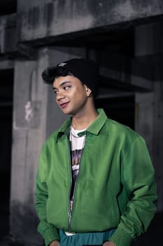 an Asian man is standing in an abandoned building in an eccentric outfit at night