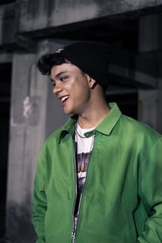 an Asian man is standing in an abandoned building in an eccentric outfit at night