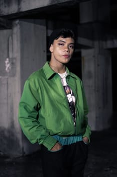 an Asian man is standing in an abandoned building in an eccentric outfit at night
