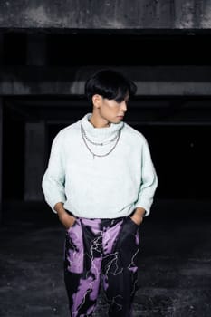 an asian man posing in a white sweater and a chain necklace around his neck in an old building