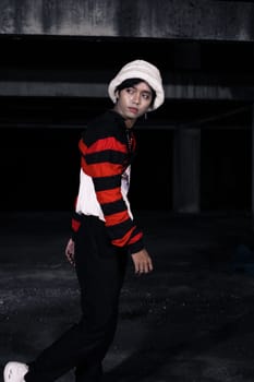 an Asian man is standing in a crimson outfit and a white hat in a haunted building