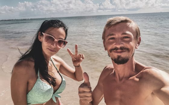 Couple man and woman together at the Caribbean beach and sea in Playa del Carmen Quintana Roo Mexico.
