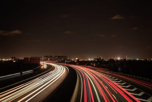 Long exposure photograph of car light trails. Car light trails on a highway entering and exiting a major city, Valencia