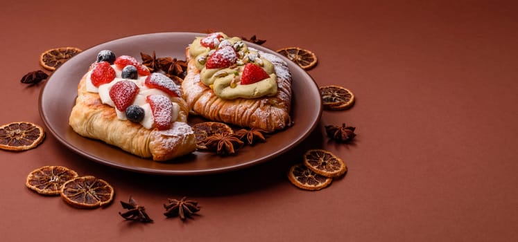 Food for breakfast sweet strawberry croissants with chocolate filling. French dessert, croissants with fruit and berries