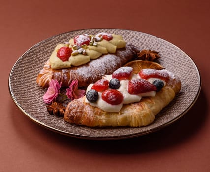 Food for breakfast sweet strawberry croissants with chocolate filling. French dessert, croissants with fruit and berries