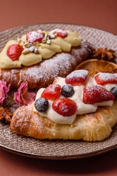 Food for breakfast sweet strawberry croissants with chocolate filling. French dessert, croissants with fruit and berries