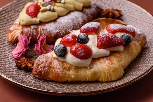 Food for breakfast sweet strawberry croissants with chocolate filling. French dessert, croissants with fruit and berries