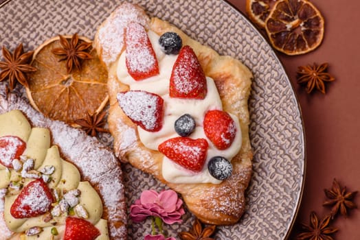 Food for breakfast sweet strawberry croissants with chocolate filling. French dessert, croissants with fruit and berries