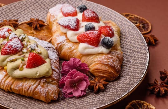 Food for breakfast sweet strawberry croissants with chocolate filling. French dessert, croissants with fruit and berries