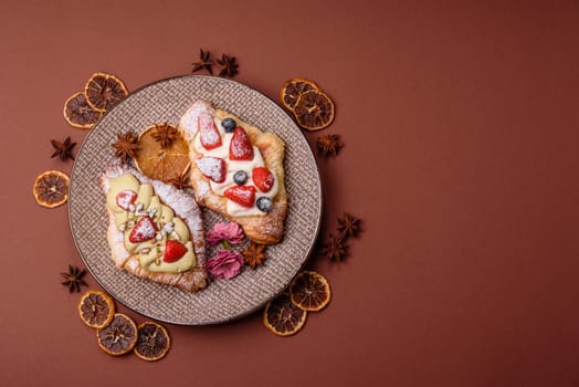 Food for breakfast sweet strawberry croissants with chocolate filling. French dessert, croissants with fruit and berries
