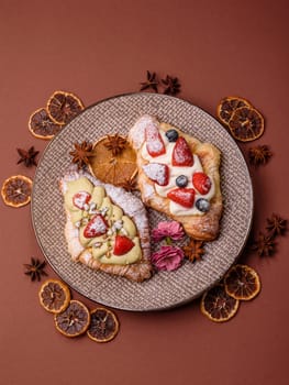 Food for breakfast sweet strawberry croissants with chocolate filling. French dessert, croissants with fruit and berries