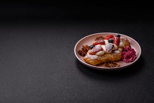 Food for breakfast sweet strawberry croissants with chocolate filling. French dessert, croissants with fruit and berries