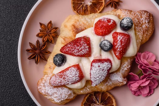 Food for breakfast sweet strawberry croissants with chocolate filling. French dessert, croissants with fruit and berries