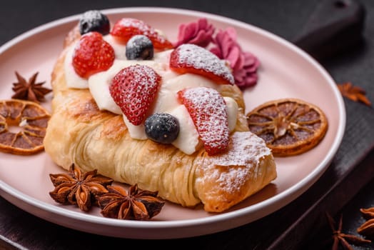 Food for breakfast sweet strawberry croissants with chocolate filling. French dessert, croissants with fruit and berries