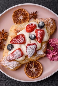 Food for breakfast sweet strawberry croissants with chocolate filling. French dessert, croissants with fruit and berries