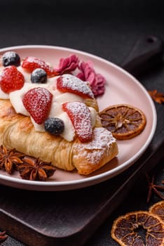 Food for breakfast sweet strawberry croissants with chocolate filling. French dessert, croissants with fruit and berries