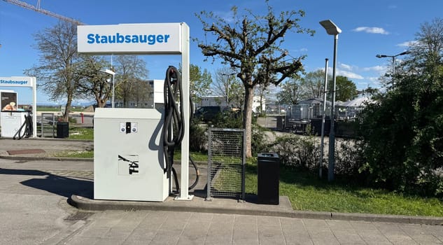 Outdoor vacuum station designed for cleaning vehicles and equipment, featuring a modern aesthetic and user-friendly setup, providing convenience for maintaining cleanliness in various settings